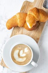 Morning coffee with croissant. Light breakfast. The atmosphere of an early calm morning.