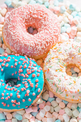 appetizing donuts with marshmallow background