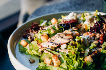 Caesar salad with chicken, Parmesan and wheat croutons on a vintage grey background. Light diet dinner.