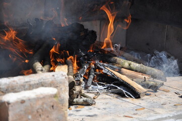Vintage fireplace. Warm Hearth taken closeup. Garden fireplace with a chimney, made of old bricks,...