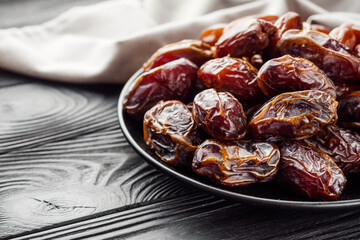 juicy royal dates on a black wooden rustic background