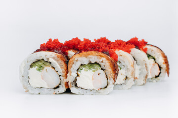 sushi rolls with eel and shrimp with masago caviar on a white background