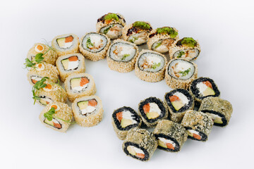 rolls with salmon cheese and avocado in sesame seeds on a white background