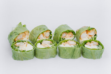 sushi rolls in lettuce with tuna salmon and cheese on a white background. restaurant menu.
