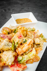 deep fried tempura vegetables on a dark background