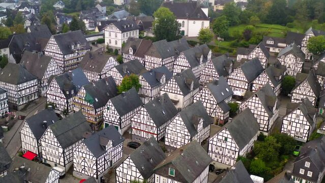 Aerial Panning Shot Of Free-Standing Residential Buildings In Town On Hills - Freudenberg, Germany
