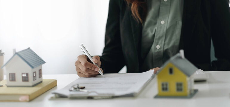Estate agent broker presentating to client decision signing agreement contract real estate with approved mortgage application, buying mortgage loan offer for and house insurance.