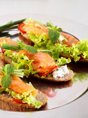 Salmon sandwich appetizers with fresh greens
