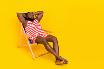 Photo guy sit deck chair sleep sun bathing wear red striped stylish trendy swim set isolated bright...
