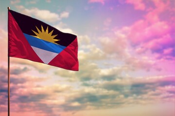 Fluttering Antigua and Barbuda flag mockup with the space for your content on colorful cloudy sky background. - obrazy, fototapety, plakaty