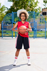 sports girl outdoors preparing for training, holding a basketball