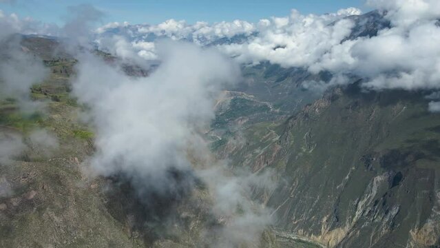 Drone flight in the Colca Canyon dawn with clouds and views towards the towns.