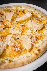 hot delicious traditional italian pizza on a dark stone background