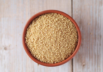 Dry couscous in a small ceramic bowl