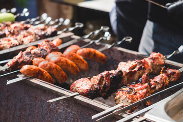 Grilled meat, vegetables and sausages on skewers