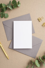 Business concept. Top view vertical photo of paper sheet two grey envelopes gold pen binder clips...