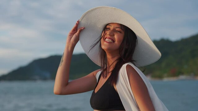Woman In Bikini And Sunhat Smiling In Sea At Sunset