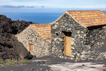 Fototapeta na wymiar Shed partial covered by lava from volcano at la Palma