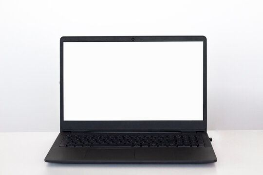 Black laptop with white mock up screen.Workspace desk, laptop. Business image, Blank screen laptop. 