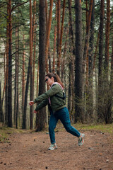 Beautiful young girl dancing in the forest 
