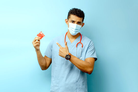 medical male holding and pointing a condom, protection and illness, aids concept.