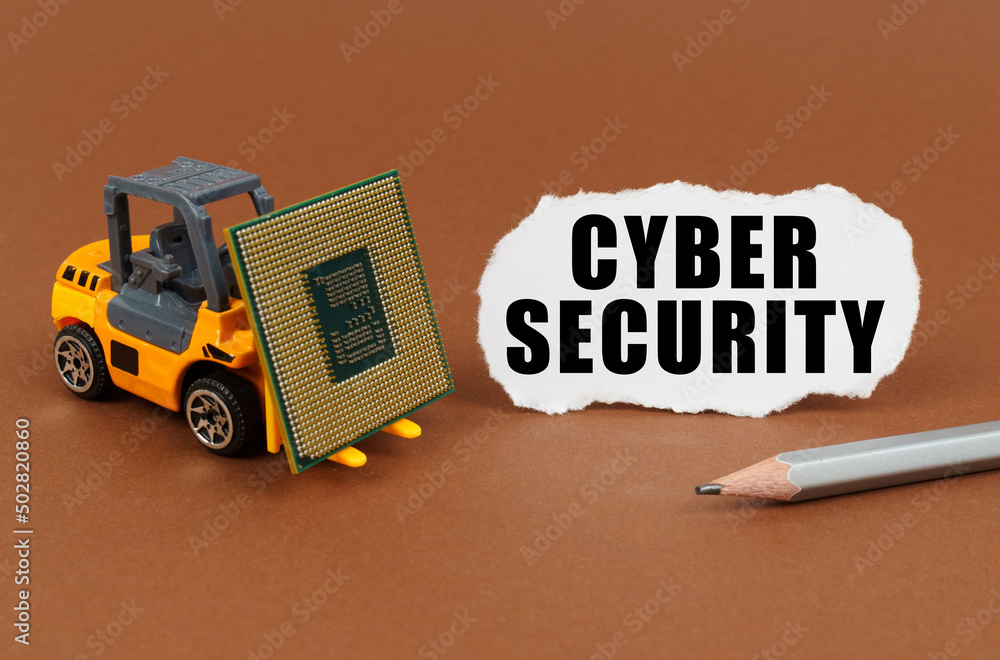 Poster on a brown surface, a forklift is transporting a processor, next to it is paper with the inscription