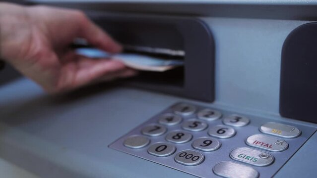 ATM concept. Enter pin code in cash machine. Close up of person typing personal pin code in ATM cash machine and withdraw cash.