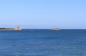 a seascape at the french coast in normandy with a vauban tower and island tatihou in the sea in saint-vaast-la-hougue - obrazy, fototapety, plakaty