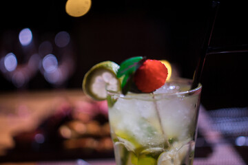 Glass of cold mojito drink with a slice of mine on it