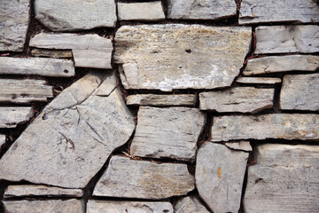 Close-up partial view of an old deteriorating stone wall