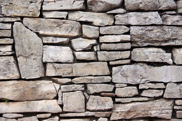 Close-up partial view of an old deteriorating stone wall