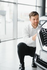 Man buying a car at a showroom