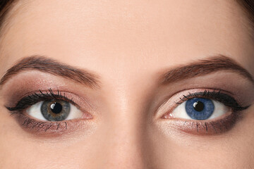Naklejka premium Woman with different colors of eyes, closeup. Heterochromia iridis