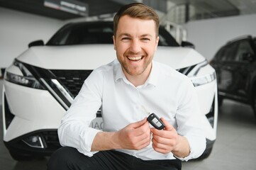 Man buying a car at a showroom