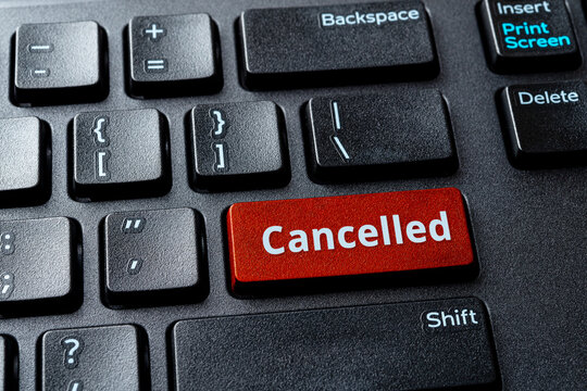 Canceled word on a red enter key of the black pc keyboard. Concepts of cancel culture, ostracism and call-out culture social media and in the Internet. Computer enter key with message.