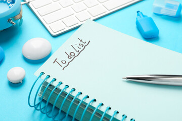 Notepad with inscription To Do List and pen on light blue table, closeup