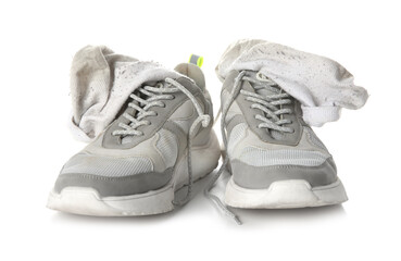 Sneakers with dirty socks on white background