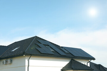 House with installed solar panels on roof, space for text. Alternative energy - obrazy, fototapety, plakaty