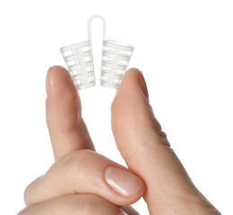 Woman holding anti-snoring device for nose on white background, closeup