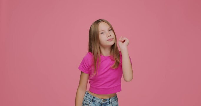 Serious funny emotional child girl warning with admonishing finger gesture, saying no, scolding showing disapproval sign