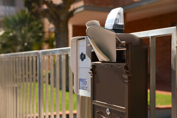 Mailbox with newspaper near house outdoors on sunny day, space for text