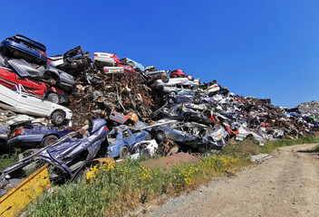 Pile of various scrap cars and other metals on a junk yard   ready  recycling industry.