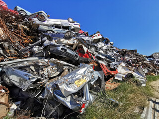 Pile of various scrap cars and other metals on a junk yard   ready  recycling industry.