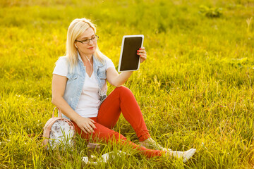 Euphoric woman searching job with a laptop in an urban park in summer.