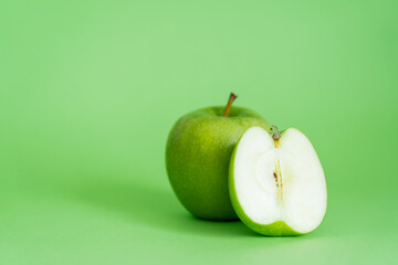 organic and fresh apples on green background.