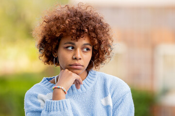 Fototapeta premium portrait of pensive african american girl on the street outdoors