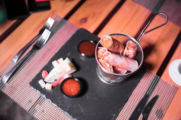 Crispy Briouats on a metallic bowl on the table