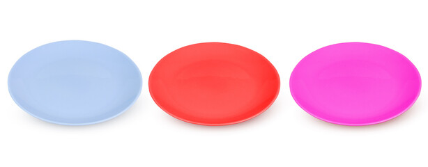 Collection or set of plates in red, blue and purple on an isolated white background. Dishes