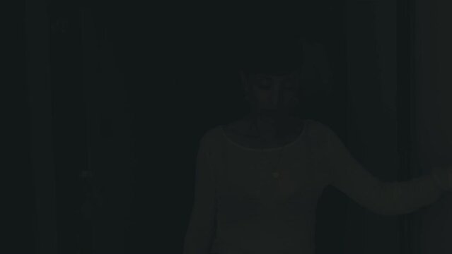 addiction, alcohol -drunk woman gropes along the corridor in the dark