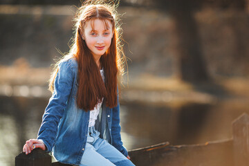 Cute red haired girl portrait. Pretty teen outdoors. Redhaired teenager.